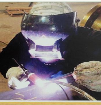 A person welding in the middle of a project.